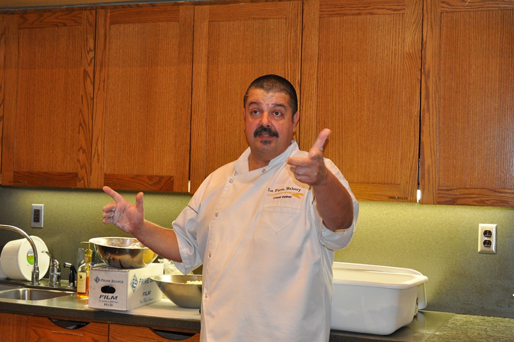 Master baker Lionel Vatinet of La Farm Bakery emphasizes a point in the art of baking bread.