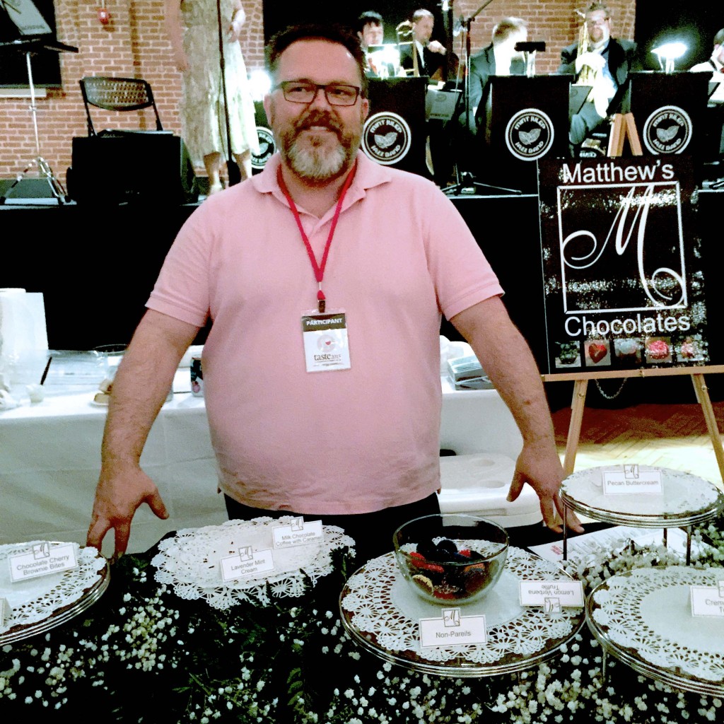 Matthew Shepherd of Matthew's Chocolates of Hillsborough, NC stands before his depleted table of decadent chocolates (use your imagination here).